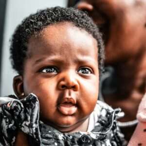 dark-skinned baby girl wearing black floral dress